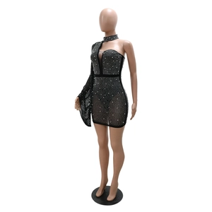 Detail of black rhinestone mesh dress featuring sheer fabric and crystal embellishments