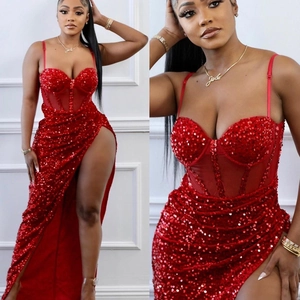 Detail of red sequin party dress featuring a high slit and corset style bodice