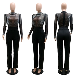 Detail of sheer mesh jumpsuit with silver rhinestones and fringe tassels on shoulders
