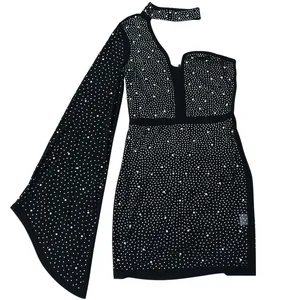 Macro detail of black evening dress with sparkling rhinestones and white pearl beads