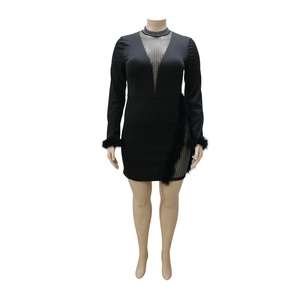 Elegant plus size black dress with rhinestones, mesh neckline and feather trim details