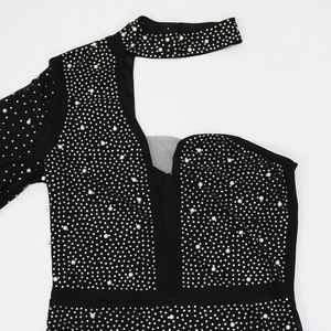 Detail of black rhinestone and pearl dress with hollow shoulder and cutout design