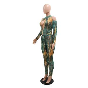 Detail of sexy tie-dye jumpsuit featuring front cutout, halter neck and waist tie detail