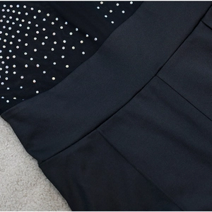 Détail de maille transparente avec des strass multicolores brillants et coutures soignées