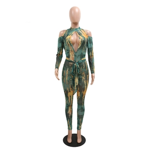 Detail of green and yellow tie-dye mesh jumpsuit with cutout front and waist tie