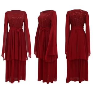 Macro view of detailed red sequins on the elegant long-sleeve evening gown's bodice