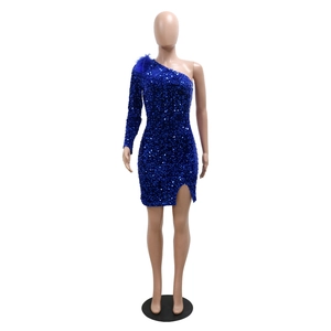 Detailed close-up of blue sequin dress featuring feather shoulder trim and slit hem