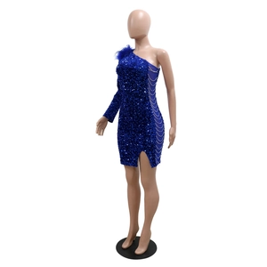 Detail of royal blue one-shoulder sequin dress with feather trim and chain cutout