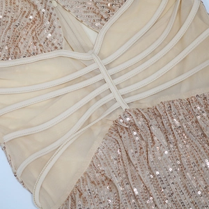 Detail of rose gold sequin dress showing crisscross straps and hidden back zipper