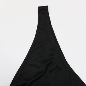 Detail of black rhinestone party dress featuring elastic fabric and dual-stitch hemline