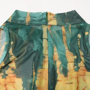 Detail of high mock neck and invisible green zipper on mesh tie-dye print jumpsuit