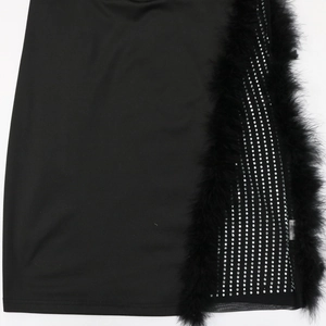 Detail of plus size black dress featuring silver rhinestones and fluffy feather trim