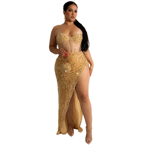 Detail of sequin evening gown featuring a corset top with boning and high slit skirt