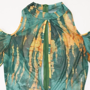 Detail view of the cold shoulder mesh top with tie-dye pattern and front zipper detail