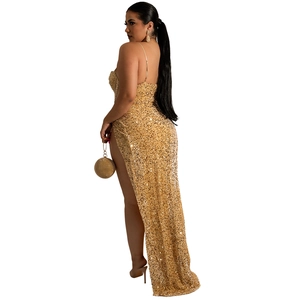 Close-up of gold sequin evening dress with high slit and long trail detail