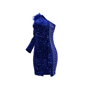 Detail of sequined royal blue dress with feather shoulder and side chain cutouts
