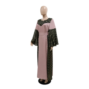 Detail view of pink Abaya showing black contrast sleeves with golden polka dot pattern