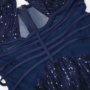 Detail of dark blue sequin party dress featuring crisscross back straps and invisible zipper