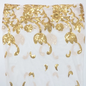 Close-up of white sheer mesh fabric with intricate gold sequin floral embroidery