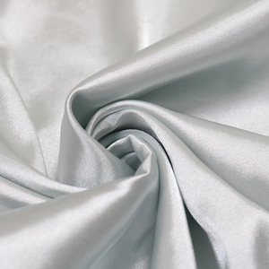 Detailed view of luxury silver-gray satin fabric with elegant drape and pearl sheen