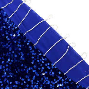 Detailed view of sequin embroidery and rhinestone fringe on elegant navy evening dress