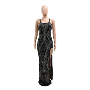 Close-up of sparkling silver rhinestones on a sexy black slit maxi party dress