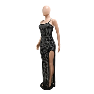Detailed close-up of sparkling silver rhinestones and high side slit on black maxi dress