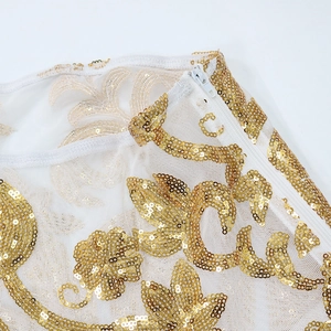 Detail of white mesh dress with golden sequins and hidden side zipper closure