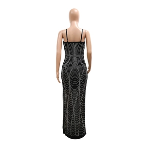 Close-up of sparkling silver rhinestone patterns on sexy black backless bodycon maxi dress
