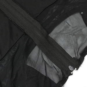 Detailed macro view of black sequin dress featuring mesh fabric and a fine zip closure