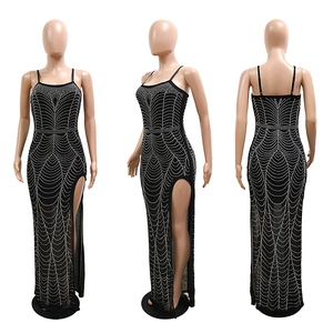 Detail view of black rhinestone maxi dress with sparkling wave patterns and side slit
