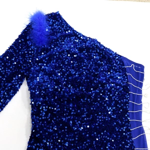 Detailed macro shot of sparkling blue sequins and soft feather trim on a luxury evening gown