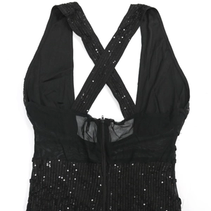Detail of cross-back straps and invisible zipper on black sequin party dress