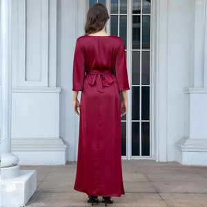 Rear view of wine red satin gown showing the elegant waist bow and sleek floor-length hem