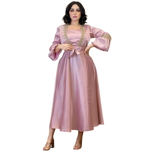 Detail of elegant lantern sleeves and gold sequin embroidery on pink satin dress
