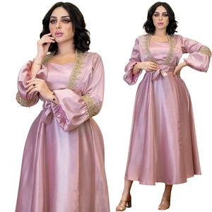 Detail of elegant pink satin dress showing gold lace embroidery and lantern sleeves