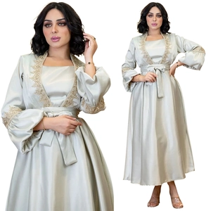 Detailed close-up of golden embroidery on gray satin lantern sleeve evening dress
