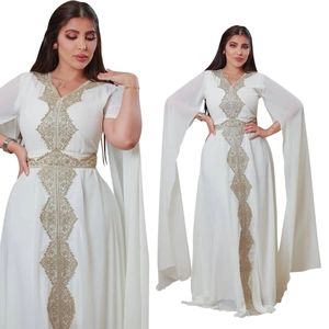 Detail of elegant white chiffon evening gown with golden embroidery and flared split sleeves