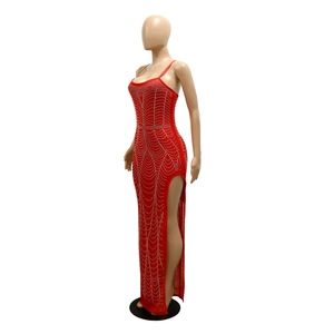 Detail showing the red dress with shimmering silver rhinestone wave patterns and thigh slit
