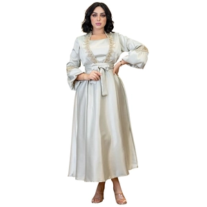 Detailed view of silver satin dress featuring golden lace embroidery on neck and lantern sleeves