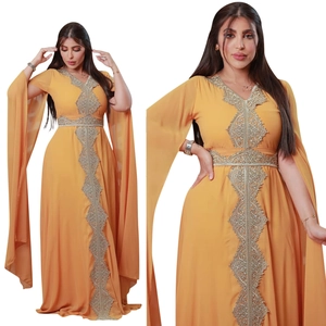 Detail of silver geometric embroidery on mustard yellow chiffon evening gown with belt
