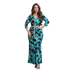 Detail of teal fishtail dress featuring floral prints and golden sequin V-neck embroidery