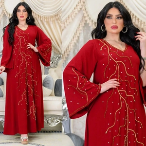Détail d'une robe Abaya rouge avec broderie de vagues dorées et perles de luxe sur manches
