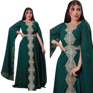 Detail of emerald green chiffon kaftan dress with intricate gold embroidery and split sleeves