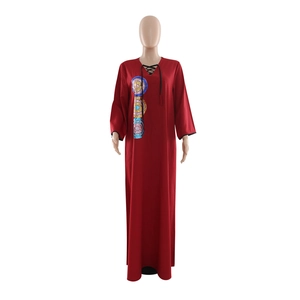 Detail of dark red loose maxi dress with sequin embroidery and V-neck tie-up tassels