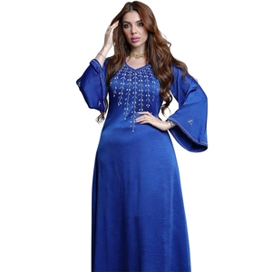 Detail of royal blue dress showing intricate gold leaf embroidery on the V-neck and flared sleeves