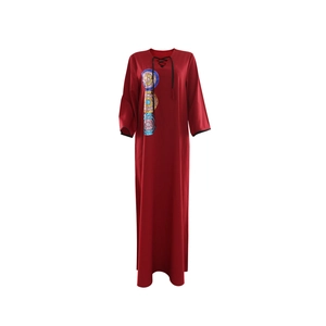 Close-up of deep red V-neck sequined embroidered kaftan dress with tassel cord details