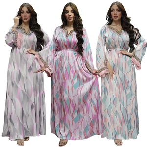Detail view of the embroidered neckline and tassels on this printed kaftan maxi dress