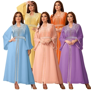 Detailed view of rhinestone embellishments and flared sleeves on chiffon kaftan dresses
