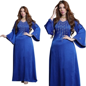 Detailed view of dark blue abaya featuring gold beaded V-neck and flared sleeves